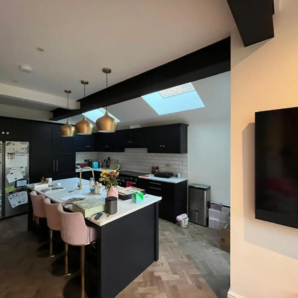 Kitchen with navy island and pendant lights